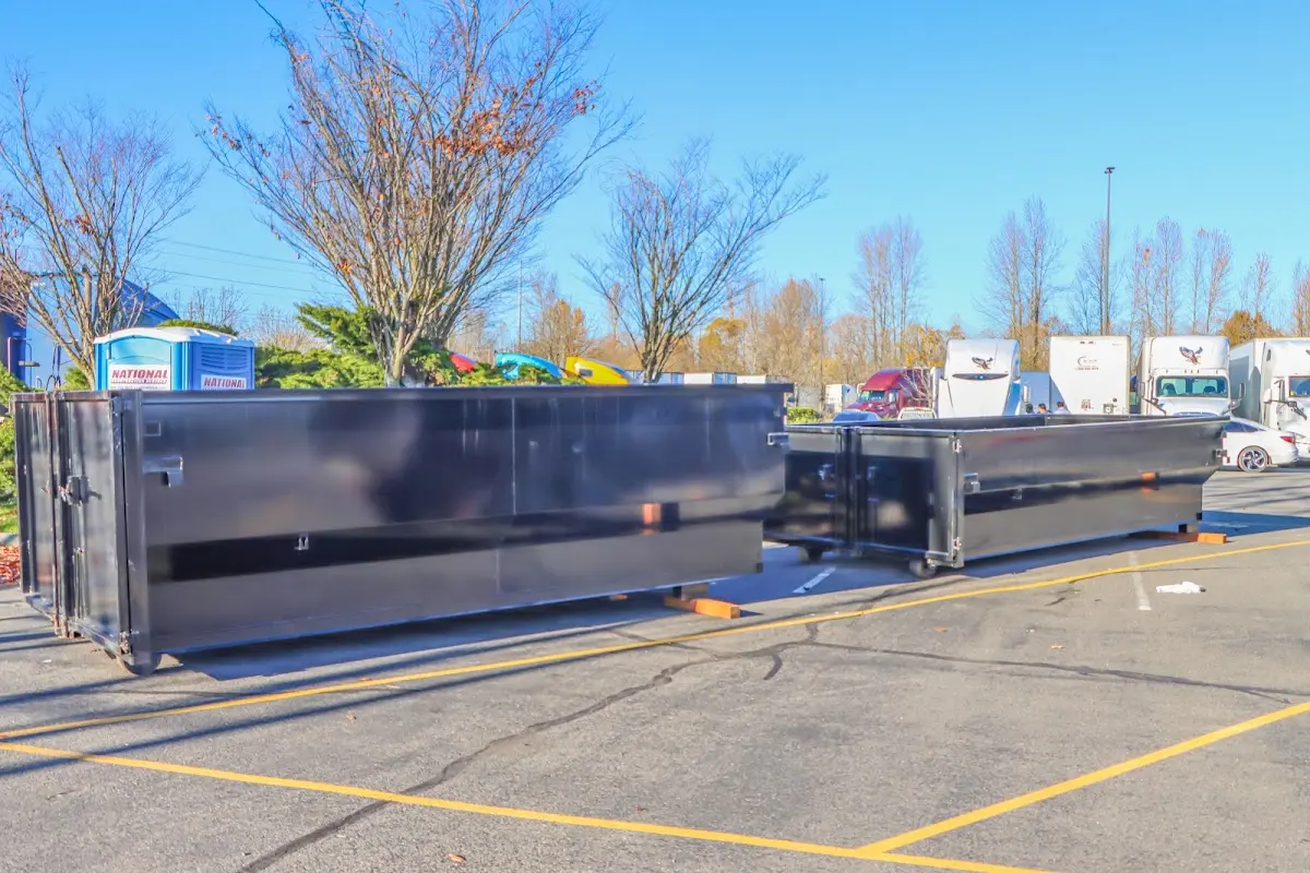 Professional dumpster rental service with roll-off container on residential driveway in Rincon